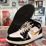 Black and gold Jordan 1 mids