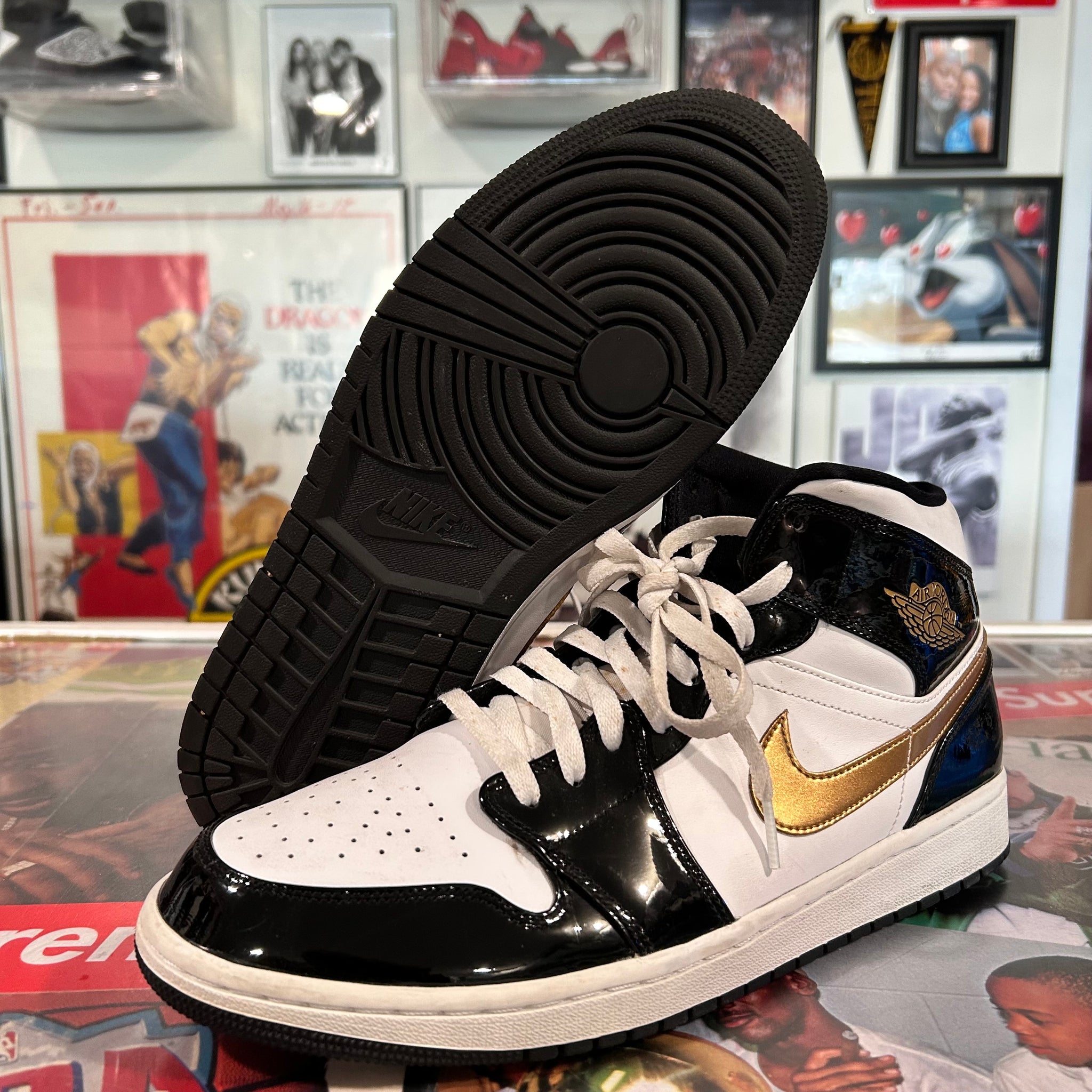 Black and gold Jordan 1 mids